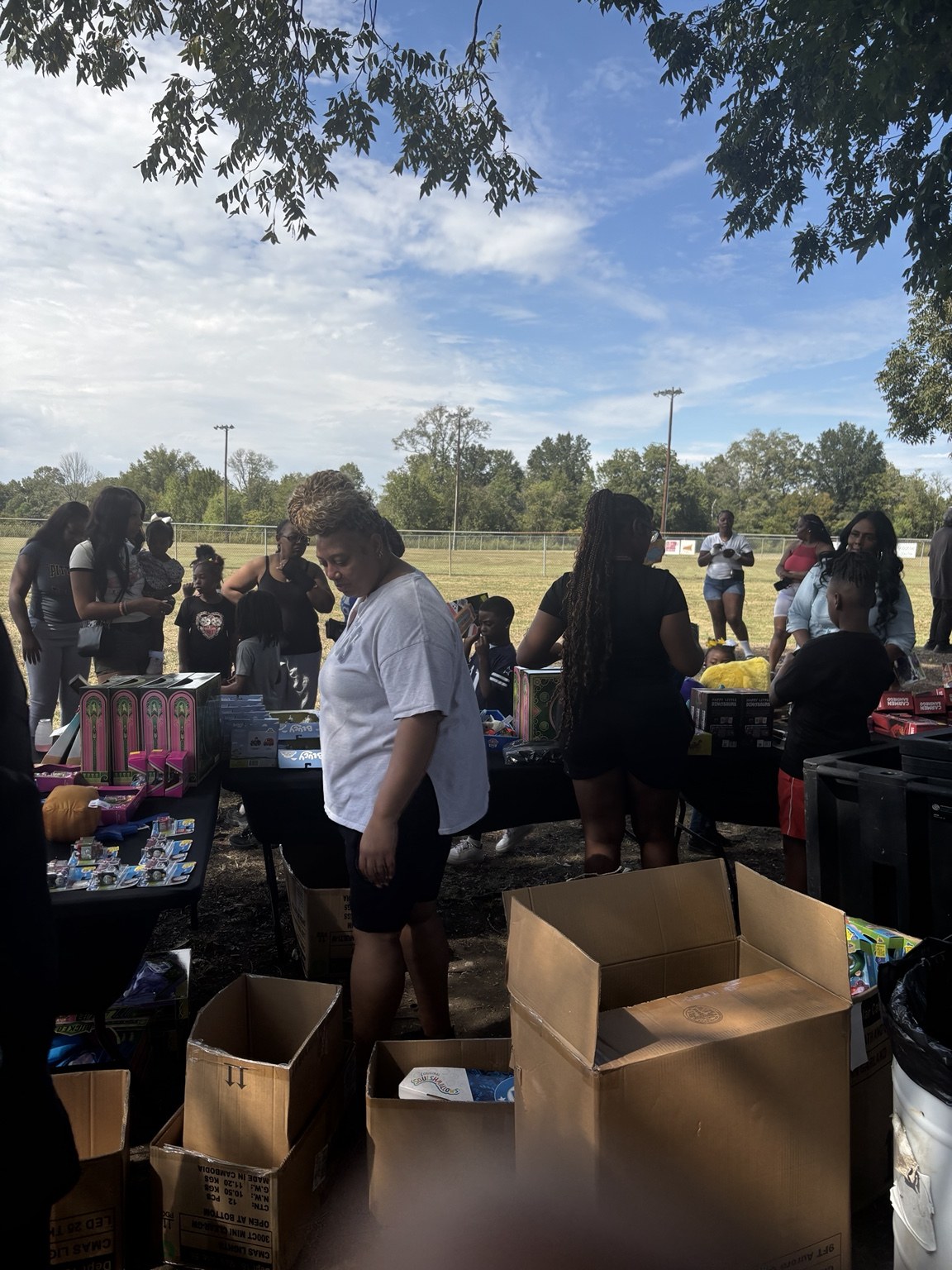 Community members gathered around an outreach table